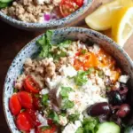 Four meal prep containers filled with lemon rice, seasoned ground turkey, fresh cucumbers, tomatoes, and feta cheese.