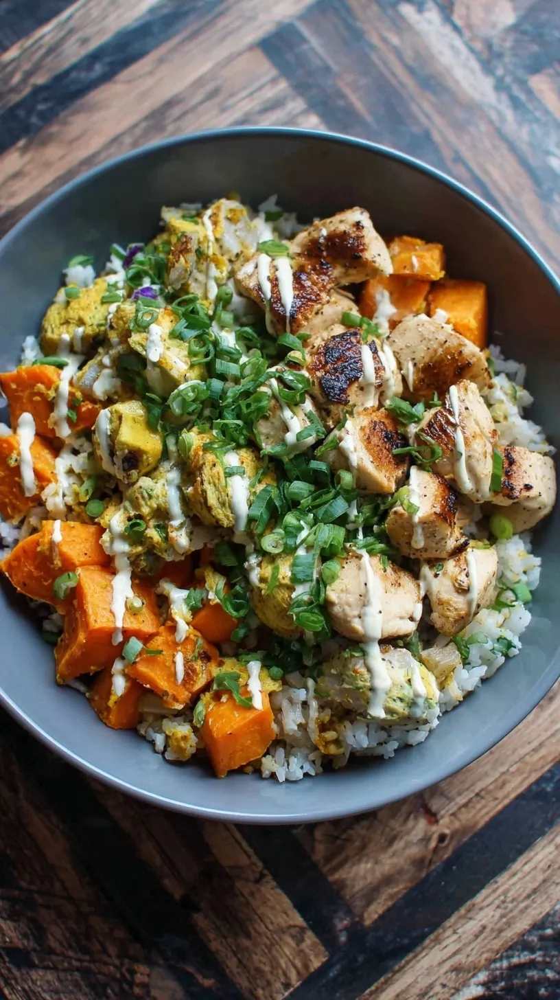 A colorful meal prep bowl with roasted chicken, cubed sweet potatoes, broccoli, and brown rice.