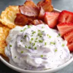 A warm bowl of high protein prepper oatmeal topped with hemp hearts and cinnamon in a rustic ceramic bowl.