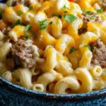 A creamy bowl of Philly cheesesteak mac and cheese with lean beef and green peppers.