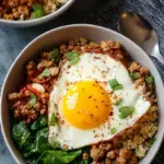 Four meal prep containers filled with roasted sweet potatoes and scrambled ground turkey with eggs