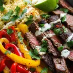 A vibrant Low Carb Steak Fajita Bowl with seared flank steak, colorful bell peppers, and cilantro lime cauliflower rice.