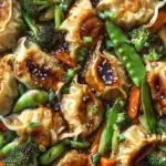 A large skillet filled with golden seared potstickers, browned ground turkey, and shredded cabbage in a savory sauce