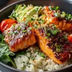 A vibrant salmon rice bowl topped with sliced avocado, fresh cucumber, and sesame seeds served with nori squares.