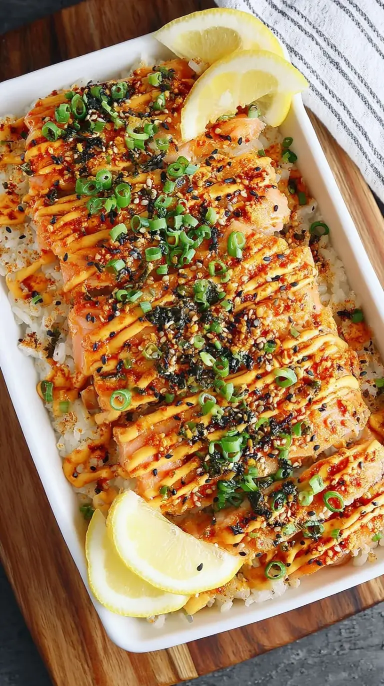 A creamy salmon sushi bake in a ceramic dish topped with green onions and unagi sauce