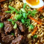 A steaming bowl of tender slow cooker beef ramen noodles with carrots and green onions.