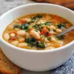 A warm bowl of Tuscan White Bean Soup with kale and carrots